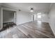 Bright living room with wood-look floors, modern lighting, neutral walls, and doorway to an additional room at 8260 E Arabian Trl # 257, Scottsdale, AZ 85258