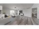 Bright living room featuring hardwood floors, comfortable seating, a TV, and access to the balcony at 8260 E Arabian Trl # 257, Scottsdale, AZ 85258
