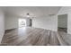 Bright living room featuring wood-look floors, neutral walls, modern lighting, and sliding glass doors to a patio at 8260 E Arabian Trl # 257, Scottsdale, AZ 85258