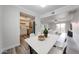 Open-concept living room featuring a dining area, modern kitchen, and sliding glass doors to the balcony at 8260 E Arabian Trl # 257, Scottsdale, AZ 85258
