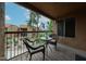 The patio includes a table and chairs and overlooks lush landscaping, offering a relaxing outdoor retreat at 8260 E Arabian Trl # 257, Scottsdale, AZ 85258