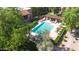 A birds eye view of a refreshing community pool with umbrella covered table, and shaded lounge chairs at 8260 E Arabian Trl # 257, Scottsdale, AZ 85258