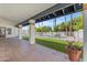 Spacious covered back patio overlooking lush backyard with pool and trees at 9736 E Turquoise Ave, Scottsdale, AZ 85258