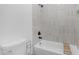 Modern bathroom with soaking tub, white tile surround, and sleek black fixtures at 9736 E Turquoise Ave, Scottsdale, AZ 85258