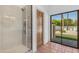 Bathroom showcasing walk-in shower, terra cotta floor tiles, and backyard view at 9736 E Turquoise Ave, Scottsdale, AZ 85258