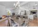 Open-concept dining area with a wood table and chairs, and a view of the kitchen and fireplace at 9736 E Turquoise Ave, Scottsdale, AZ 85258