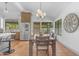 Dining area featuring a wood table and chairs, a decorative clock, and natural light from large windows at 9736 E Turquoise Ave, Scottsdale, AZ 85258