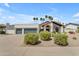 Charming single story home with a stucco exterior, terracotta roof, manicured landscaping, and a three car garage at 9736 E Turquoise Ave, Scottsdale, AZ 85258