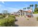 Charming single-story home with a stucco exterior, red tile roof, desert landscaping, and palm trees at 9736 E Turquoise Ave, Scottsdale, AZ 85258