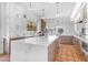Bright kitchen featuring a large island, shaker cabinets, stainless steel appliances, and terracotta flooring at 9736 E Turquoise Ave, Scottsdale, AZ 85258