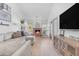 Bright living room with a fireplace, neutral furniture, and hardwood floors at 9736 E Turquoise Ave, Scottsdale, AZ 85258
