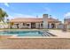 Backyard pool with stone surround, fence, and covered patio at 9736 E Turquoise Ave, Scottsdale, AZ 85258