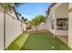 Backyard featuring an artificial turf putting green and lush tree at 9736 E Turquoise Ave, Scottsdale, AZ 85258