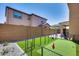 Fenced backyard featuring a putting green, landscaping, and a private setting at 9916 E Texas Ave, Mesa, AZ 85212