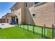 Green backyard with artificial turf putting green and covered patio, perfect for outdoor enjoyment at 9916 E Texas Ave, Mesa, AZ 85212