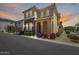 This two-story home has an elegant arched entry and manicured landscaping at 9916 E Texas Ave, Mesa, AZ 85212