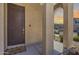 The home has a brown front door and beige exterior at 9916 E Texas Ave, Mesa, AZ 85212