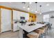 Bright kitchen with white cabinets, an island with barstool seating, and stainless steel appliances at 9916 E Texas Ave, Mesa, AZ 85212