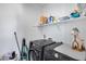 Well-organized laundry room with modern appliances, shelving, and ample storage space at 9916 E Texas Ave, Mesa, AZ 85212