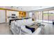 Bright, open-concept living room with an island, a large white sectional, and modern decor at 9916 E Texas Ave, Mesa, AZ 85212