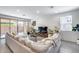 Comfortable living room with a large sectional couch and sliding glass doors to the backyard at 9916 E Texas Ave, Mesa, AZ 85212