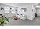 Cozy living room featuring a white sofa, a brown ottoman, and plenty of natural light at 9916 E Texas Ave, Mesa, AZ 85212