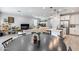 Open-concept living space with an island, dining table, and a comfortable seating area at 9916 E Texas Ave, Mesa, AZ 85212