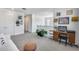Spacious loft with white walls, a desk area, and plenty of natural light from multiple windows at 9916 E Texas Ave, Mesa, AZ 85212