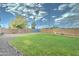 Spacious backyard with lush green grass, rock border, and block wall fence, perfect for outdoor activities at 10016 N 39Th Dr, Phoenix, AZ 85051
