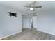 Well lit bedroom with closet, ceiling fan, and view to the ensuite bathroom at 10016 N 39Th Dr, Phoenix, AZ 85051
