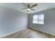 Cozy bedroom with ceiling fan, light colored walls, and wood look tile flooring at 10016 N 39Th Dr, Phoenix, AZ 85051