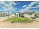 Inviting single-story home featuring a circular green lawn, a basketball hoop, and a well-maintained exterior at 10016 N 39Th Dr, Phoenix, AZ 85051