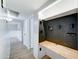 Hallway featuring built-in desk, drawers, peg board, and white wainscotting at 10016 N 39Th Dr, Phoenix, AZ 85051