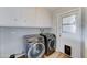 A spacious laundry room with side-by-side washer and dryer and plenty of storage at 10016 N 39Th Dr, Phoenix, AZ 85051