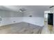 Bright living room with wood-look floors, ceiling fan, wainscotting, and open access to other rooms at 10016 N 39Th Dr, Phoenix, AZ 85051