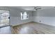 Bright living room with wood-look floors, a ceiling fan, and a large window for ample natural light at 10016 N 39Th Dr, Phoenix, AZ 85051