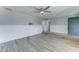 Spacious living room featuring wood-look floors, ceiling fan, wainscotting and views to multiple rooms at 10016 N 39Th Dr, Phoenix, AZ 85051