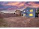 Spacious backyard with ample room, complemented by a home featuring an inviting covered patio and warm lighting at 10831 E Azalea Ave, Mesa, AZ 85208