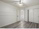This clean bedroom has wood-look floors, double closets, and white trim at 10831 E Azalea Ave, Mesa, AZ 85208