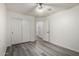 This clean bedroom has wood-look floors, double closets, and white trim at 10831 E Azalea Ave, Mesa, AZ 85208