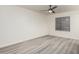 The bedroom has modern flooring, a ceiling fan, and a window for natural light at 10831 E Azalea Ave, Mesa, AZ 85208