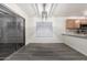Dining area with gray flooring, modern chandelier, large sliding doors, and open access to the kitchen at 10831 E Azalea Ave, Mesa, AZ 85208