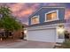 Charming two-story home featuring a large two car garage, beautiful blue siding, and a lovely tiled roof at 10831 E Azalea Ave, Mesa, AZ 85208