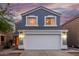 Charming two-story home featuring a large two car garage, beautiful blue siding, and a lovely tiled roof at 10831 E Azalea Ave, Mesa, AZ 85208