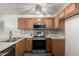 This kitchen features stainless steel appliances, wood cabinets, and a mosaic tile backsplash at 10831 E Azalea Ave, Mesa, AZ 85208