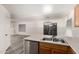 The kitchen showcases stainless steel appliances and transitions to the dining and living area at 10831 E Azalea Ave, Mesa, AZ 85208