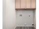 The laundry room has overhead cabinets and hookups for a washer and dryer at 10831 E Azalea Ave, Mesa, AZ 85208