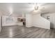 Open floor plan showcasing gray flooring, ceiling fan, access to kitchen and stairs, and freshly painted walls at 10831 E Azalea Ave, Mesa, AZ 85208