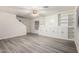 Bright living room featuring gray flooring, a ceiling fan, built-in shelving and storage at 10831 E Azalea Ave, Mesa, AZ 85208