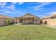 Spacious backyard features lush green grass, a covered patio, and a well-maintained perimeter fence at 12605 W Dreyfus Dr, El Mirage, AZ 85335